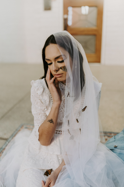 Bride with butterflies on veil.
