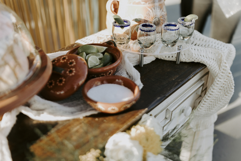 Ceremony reception table with tequila, salt and limes.