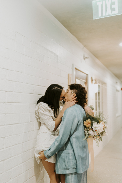 Bride and groom kissing in hallway of Ferguson's.