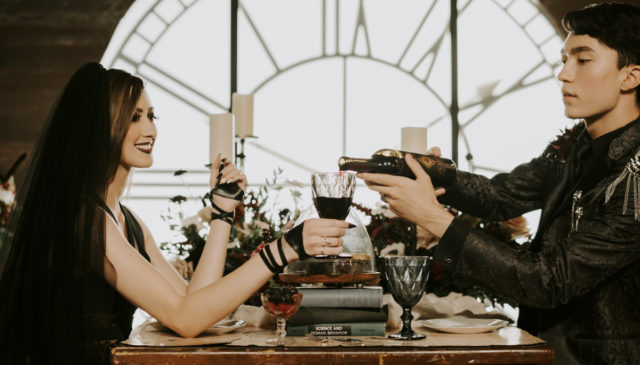 Groom pouring wine for wife.