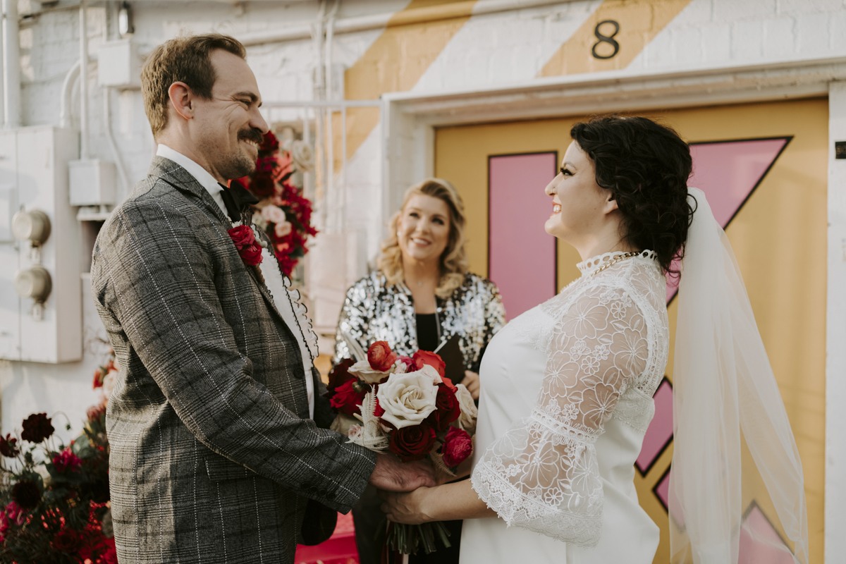 groom and bride exchange vows in front of officiant