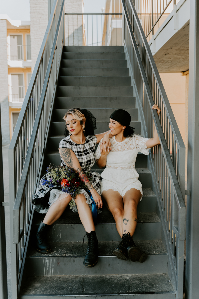 two brides sitting on stairs