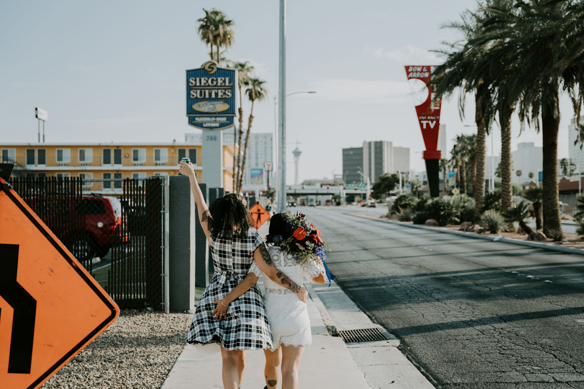 two brides in funky dresses walking away